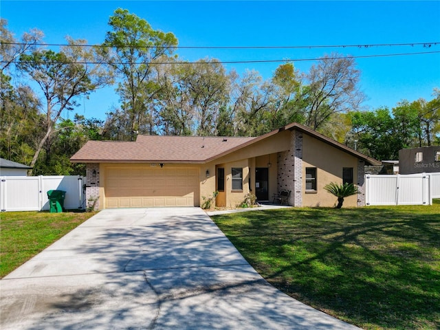 view of front of property featuring a garage, driveway, a front lawn, and a gate