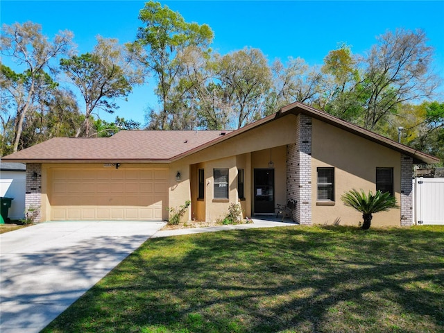 view of front of property featuring a front lawn, concrete driveway, a garage, and stucco siding