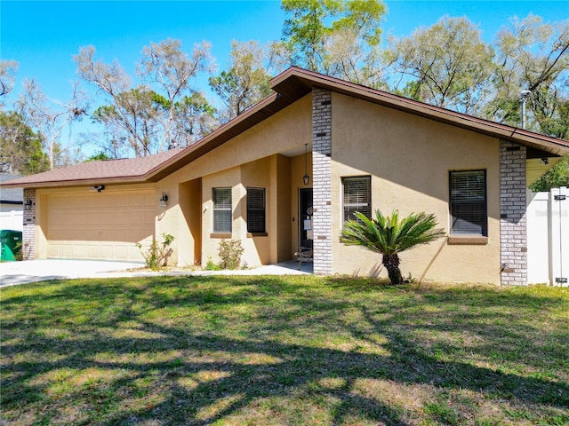 view of front facade featuring stucco siding, driveway, a garage, and a front lawn