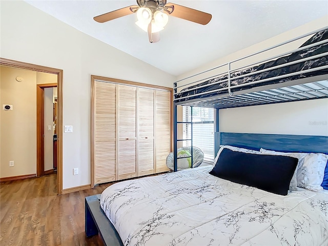 bedroom with wood finished floors, baseboards, lofted ceiling, ceiling fan, and a closet