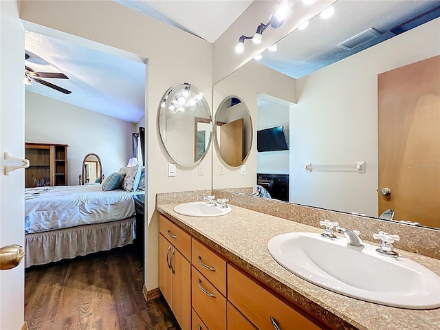 ensuite bathroom featuring ceiling fan, ensuite bath, visible vents, and a sink