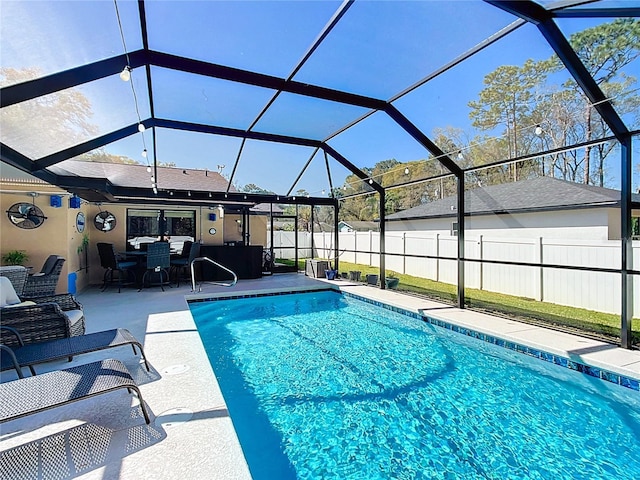 view of swimming pool with a patio area, a fenced in pool, a lanai, and fence