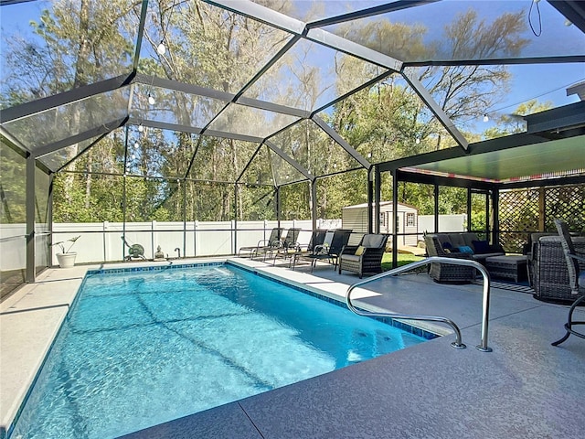 view of swimming pool with a storage unit, a patio, a fenced backyard, an outdoor structure, and an outdoor hangout area