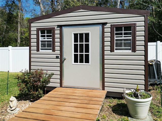 view of shed featuring fence