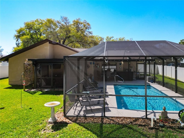 rear view of property featuring stucco siding, a lawn, a patio, fence, and a fenced in pool