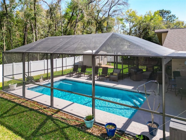 view of swimming pool with a lanai, a fenced backyard, a fenced in pool, and a patio area