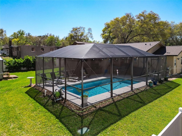 outdoor pool featuring a yard, a lanai, and a patio area