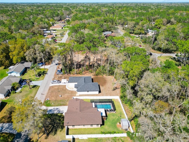 drone / aerial view featuring a view of trees