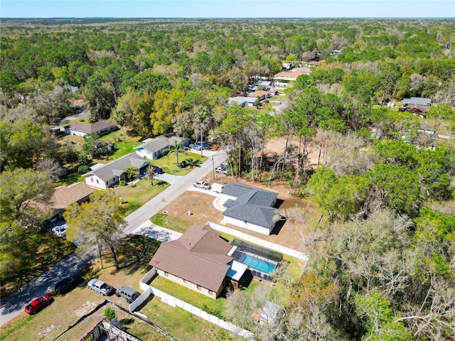 drone / aerial view featuring a view of trees and a residential view