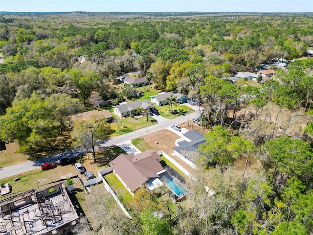 birds eye view of property with a view of trees and a residential view