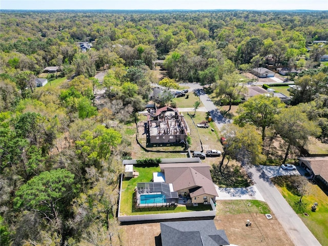 birds eye view of property with a view of trees