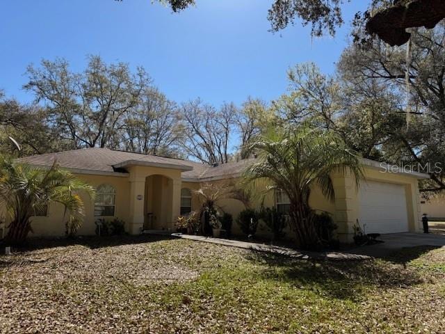 view of front facade featuring a garage and stucco siding