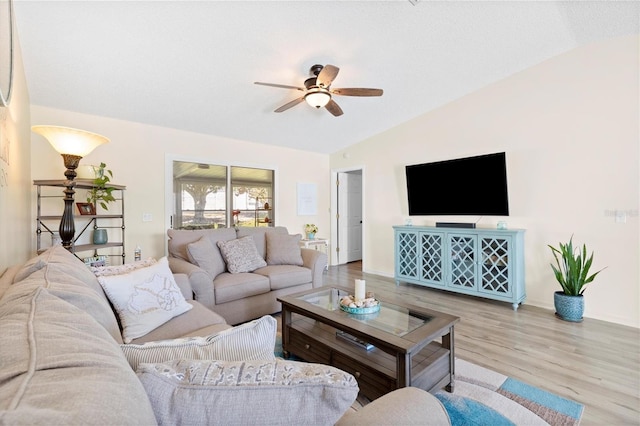 living area with wood finished floors and a ceiling fan