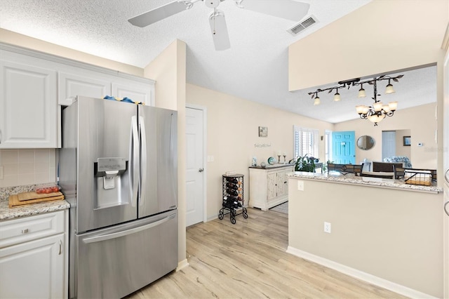 kitchen featuring a ceiling fan, visible vents, light wood finished floors, stainless steel fridge with ice dispenser, and white cabinets