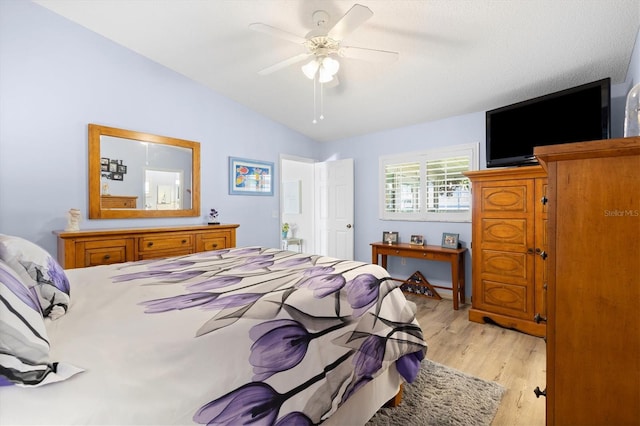 bedroom featuring lofted ceiling, ceiling fan, and light wood finished floors