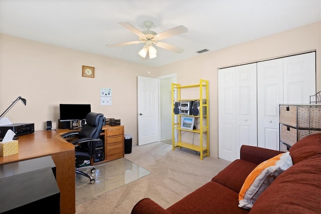 office area with visible vents, carpet floors, and a ceiling fan