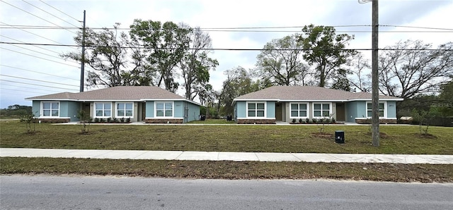 5975 NW 6th Pl, Ocala, FL 34482 - ranch-style house with a front yard and stucco siding