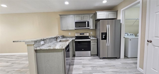 5975 NW 6th Pl, Ocala, FL 34482 - kitchen featuring appliances with stainless steel finishes, gray cabinets, a sink, and washer / dryer