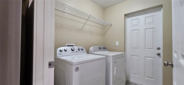 5975 NW 6th Pl, Ocala, FL 34482 - laundry room with a textured wall, laundry area, and separate washer and dryer