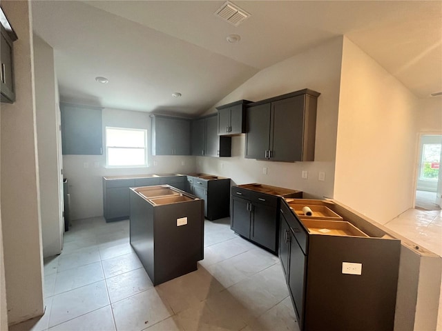 4365 SW 90th Pl, Ocala, FL 34476 - kitchen featuring lofted ceiling, a center island, and light tile patterned flooring