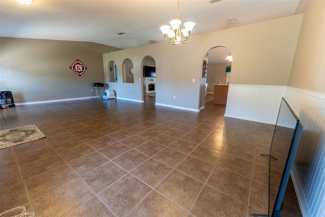 unfurnished living room with visible vents, tile patterned floors, a chandelier, vaulted ceiling, and arched walkways