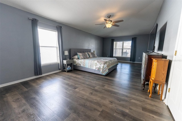 unfurnished bedroom featuring ceiling fan, baseboards, dark wood-style floors, and vaulted ceiling