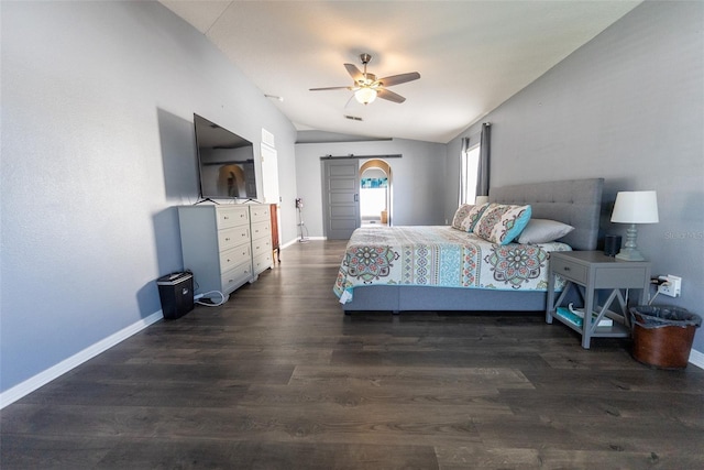 bedroom with a barn door, baseboards, dark wood-style flooring, and vaulted ceiling