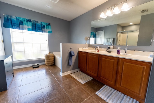 bathroom with a shower stall, double vanity, a bath, tile patterned floors, and a sink