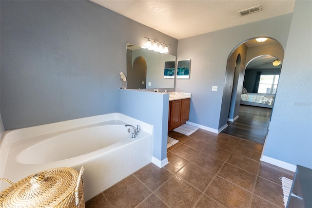 full bath with vanity, visible vents, tile patterned floors, a bath, and connected bathroom