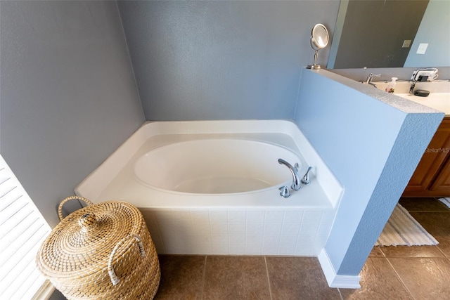 bathroom with a bath and tile patterned floors