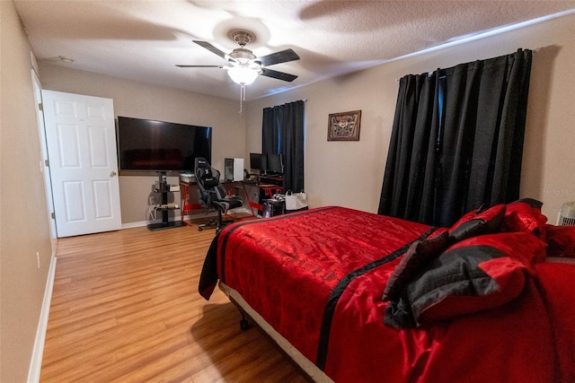 bedroom with baseboards, a ceiling fan, and wood finished floors