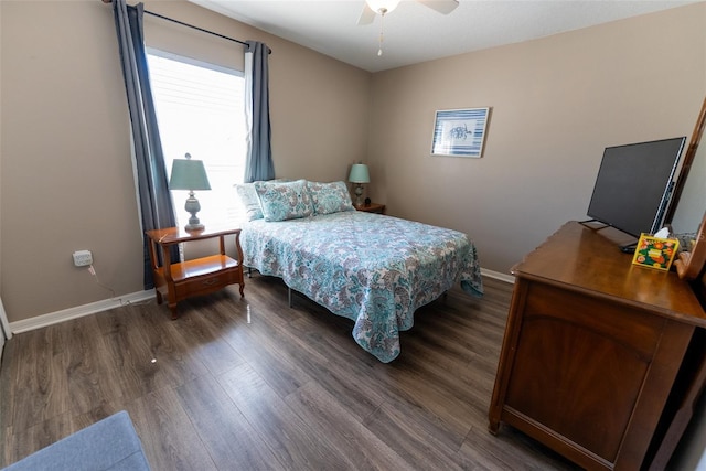 bedroom with a ceiling fan, dark wood-style floors, and baseboards