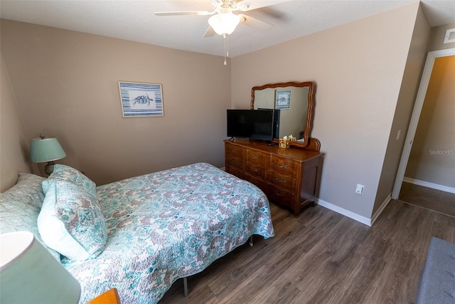 bedroom featuring visible vents, wood finished floors, baseboards, and ceiling fan