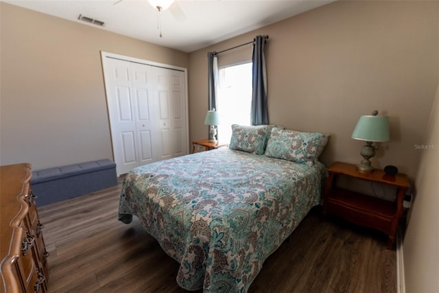 bedroom featuring wood finished floors, visible vents, a closet, and ceiling fan