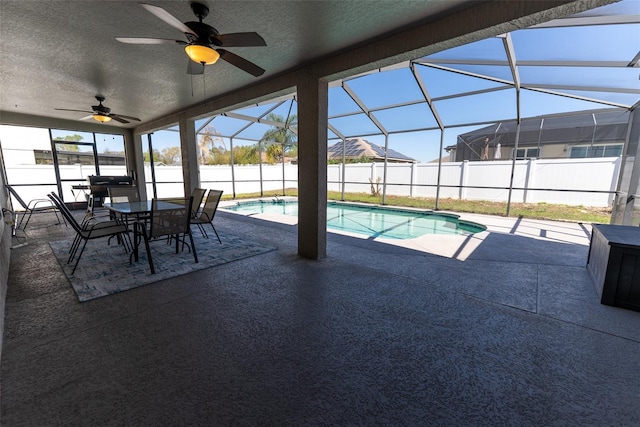 view of pool featuring a patio area, a lanai, a ceiling fan, and fence