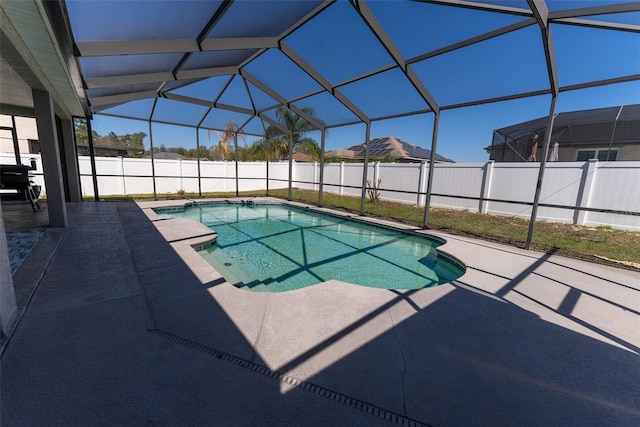 view of pool featuring glass enclosure, a patio, a fenced in pool, and fence private yard