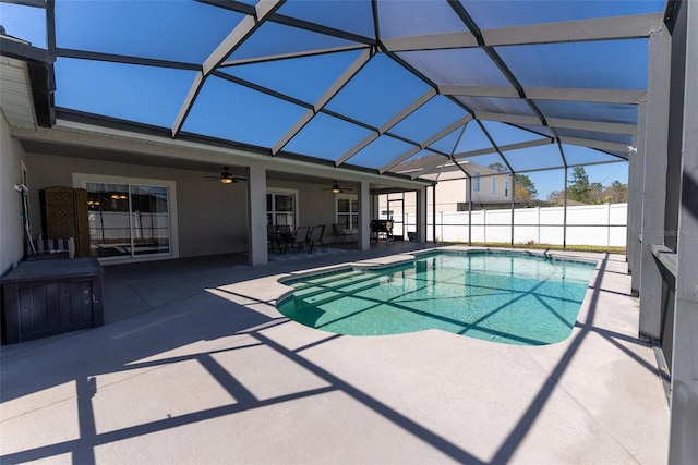 view of swimming pool with a fenced in pool, fence, glass enclosure, a patio, and a ceiling fan