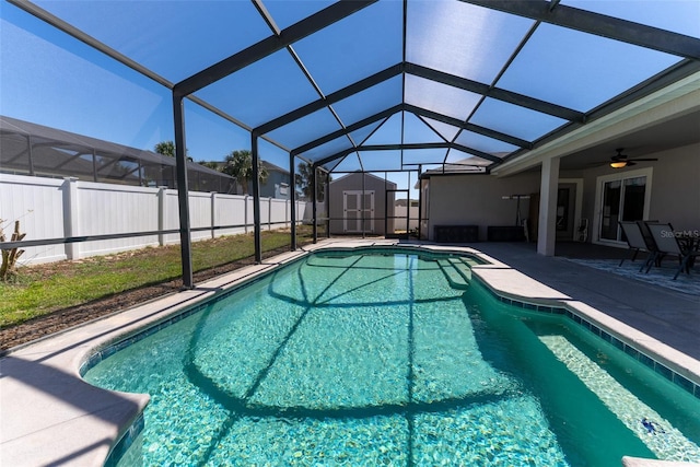 view of pool with a patio area, a lanai, a storage shed, and an outdoor structure