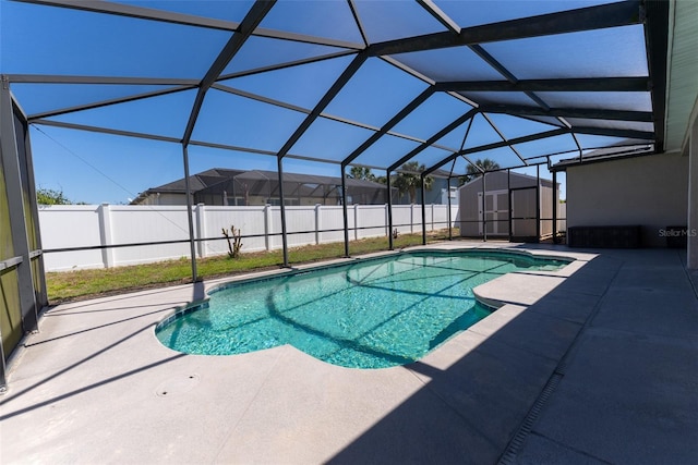 view of pool featuring a storage shed, a fenced backyard, and a patio