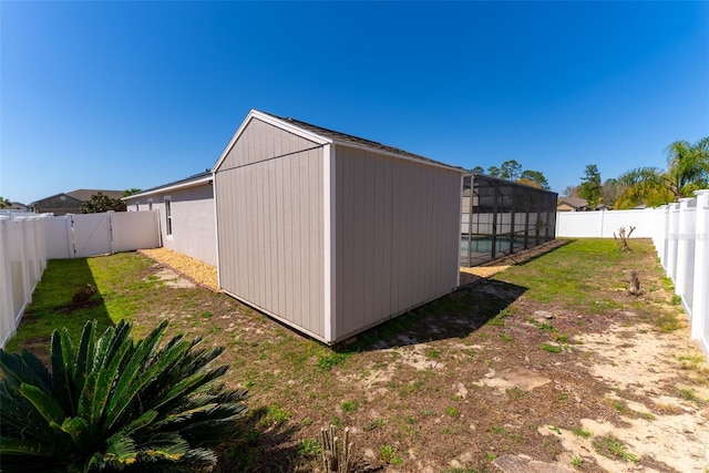 view of outdoor structure featuring a fenced in pool and a fenced backyard