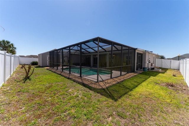 view of swimming pool with a lanai, a lawn, and a fenced backyard