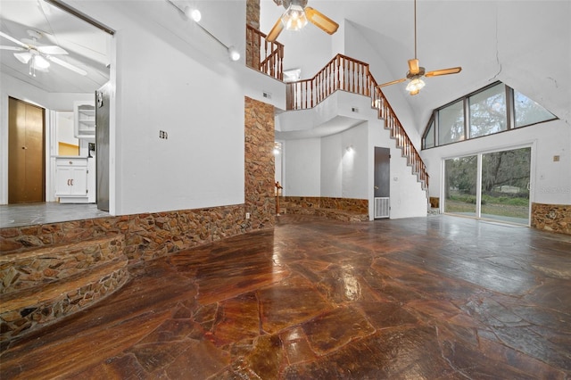 unfurnished living room featuring stairway, marble finish floor, and ceiling fan