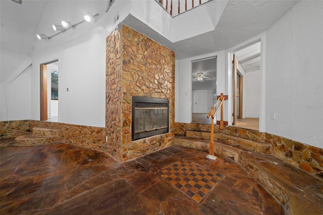 interior space with heating unit, visible vents, a fireplace, and stone finish flooring