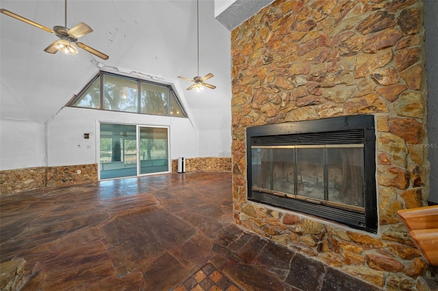 interior space with a glass covered fireplace and a ceiling fan