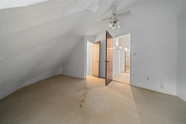 additional living space with lofted ceiling and carpet