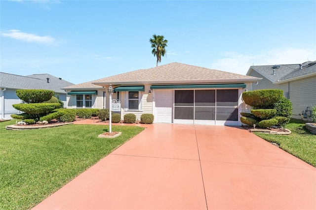 ranch-style home featuring a garage, driveway, and a front lawn