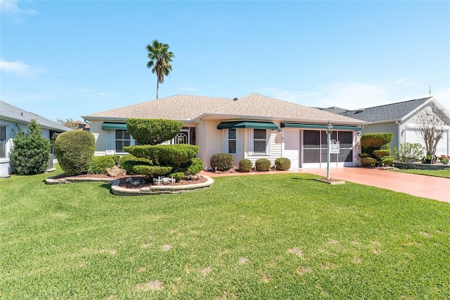 ranch-style home featuring a garage, driveway, a shingled roof, and a front lawn