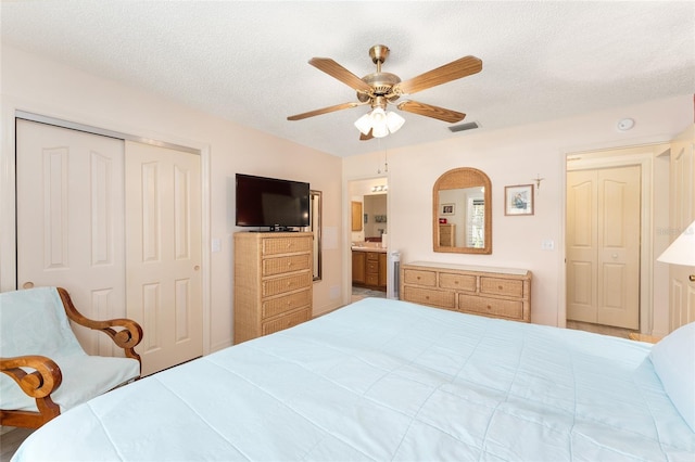 bedroom featuring a closet, a textured ceiling, visible vents, and a ceiling fan