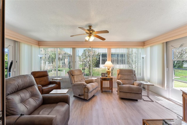 sunroom with a textured ceiling and wood finished floors