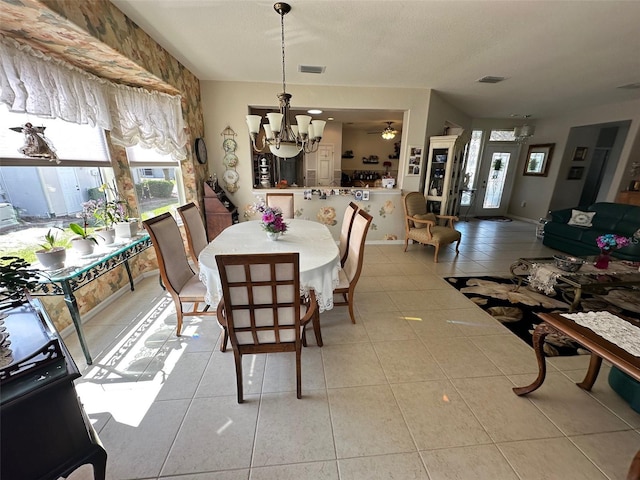 dining area featuring light tile patterned floors, ceiling fan with notable chandelier, and visible vents